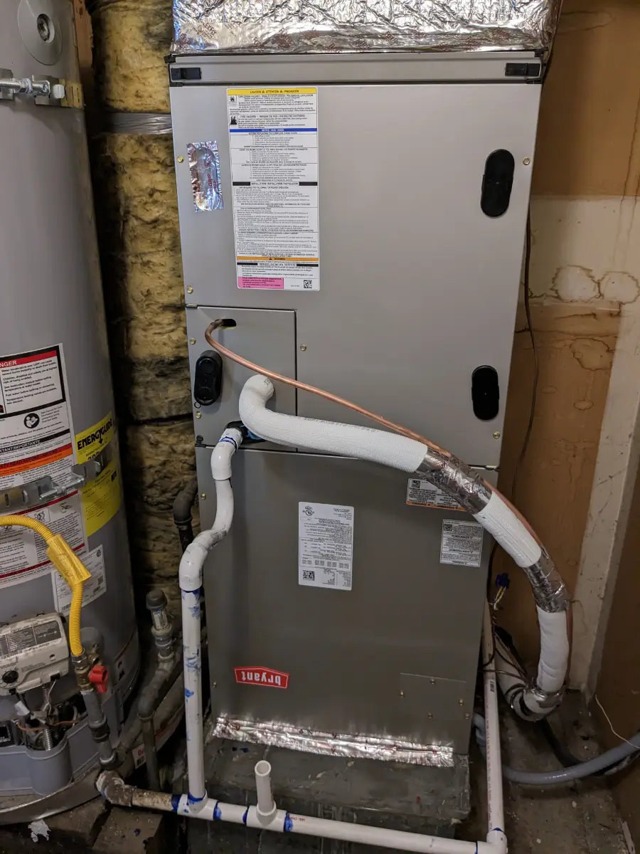 A picture of an air conditioner unit in the process of being installed.