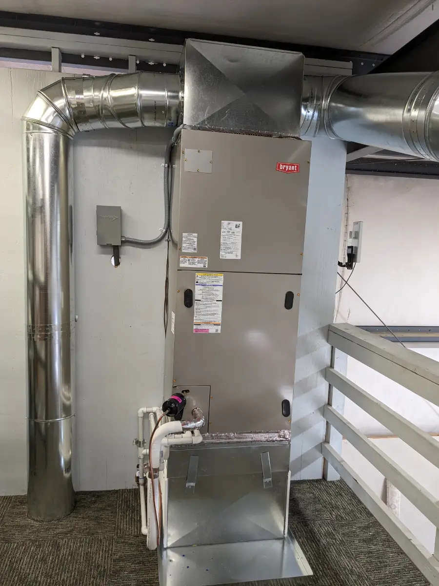 A large air handler in the middle of an industrial building.