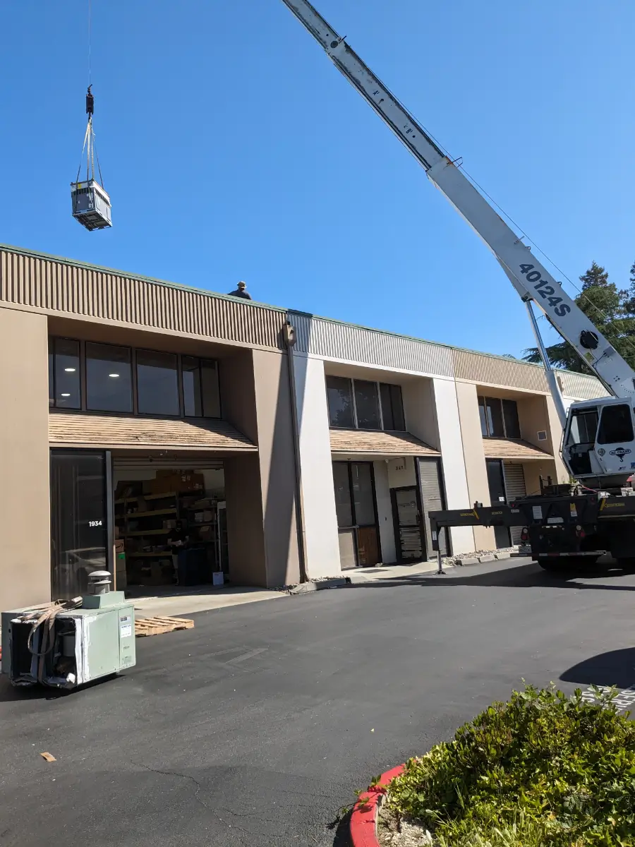 A crane is in front of a building