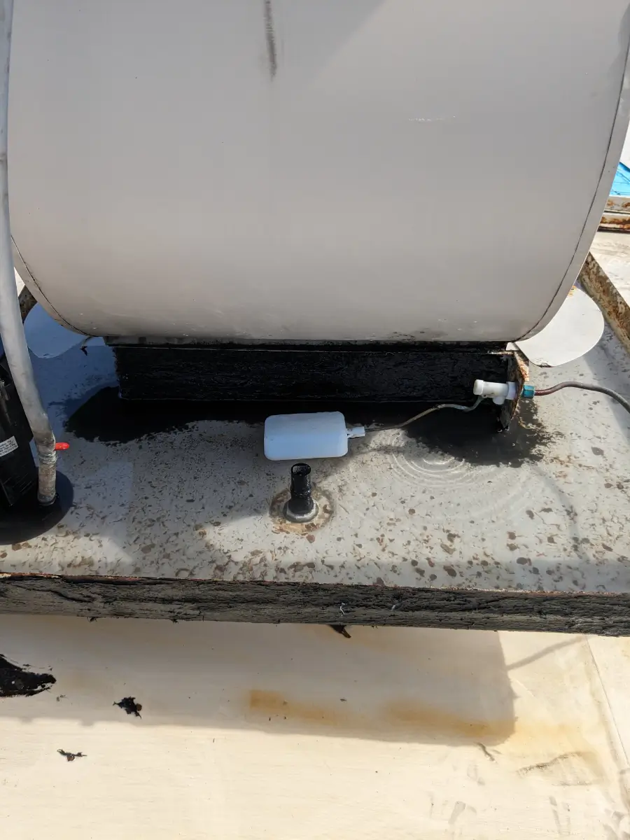 A white and black device sitting on top of concrete.