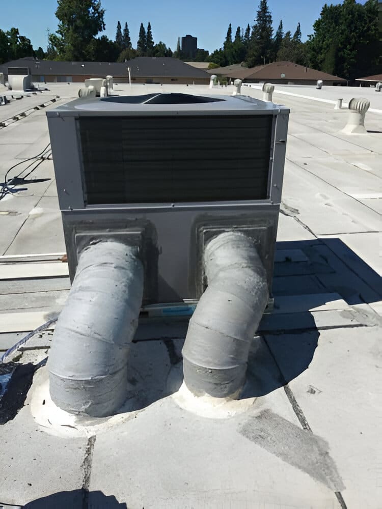 A large air conditioner on the roof of a building.